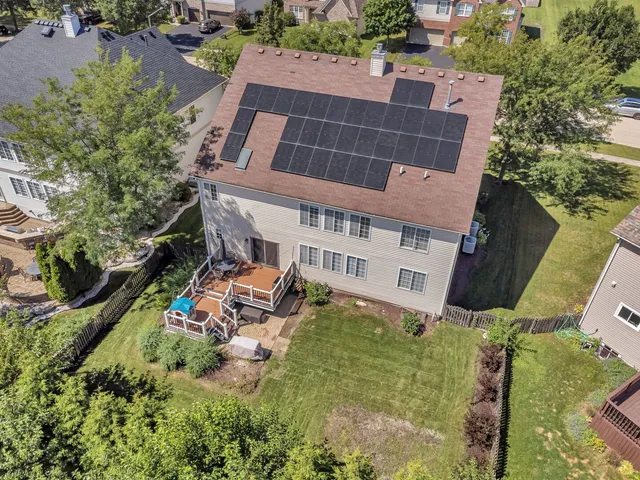 a aerial view of a house with a yard
