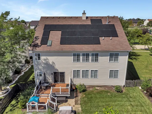 aerial view of a house with a yard
