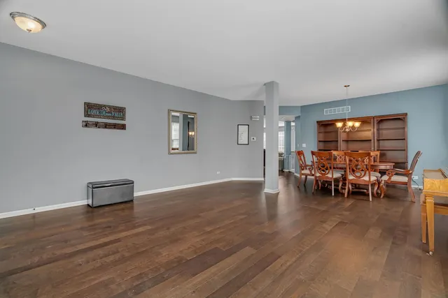 a dining room with furniture and wooden floor