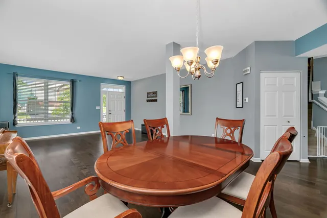a dining room with furniture and chandelier