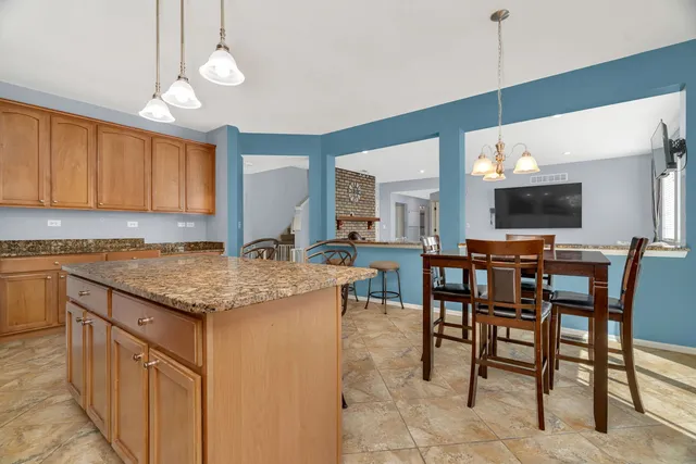 a kitchen with a table and chairs in it