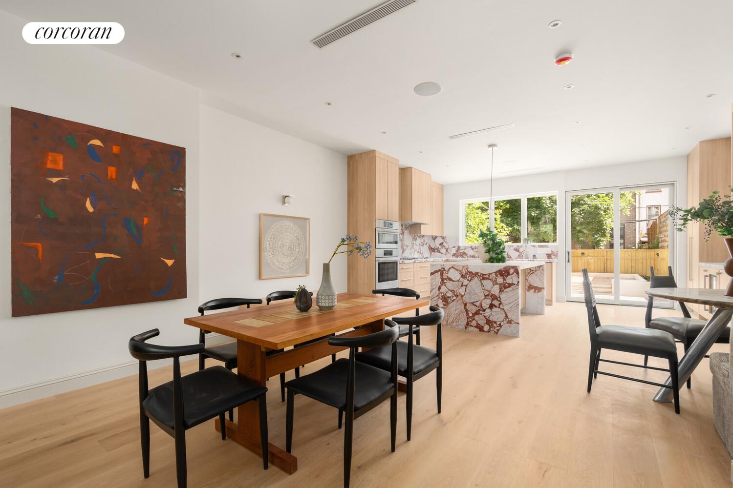 700 Monroe Street Brooklyn, NY 11221 - Photo 3 of 18 a view of a dining room with furniture and wooden floor