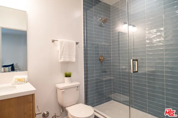 a white toilet sitting next to a bathroom sink
