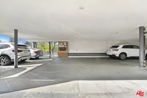 a view of street with parked cars