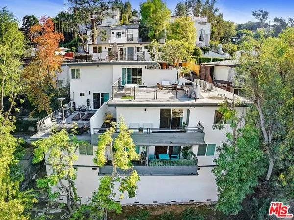 a aerial view of a house with a yard and sitting area