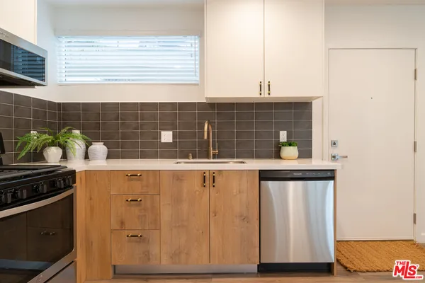 a kitchen with a sink and wooden cabinets