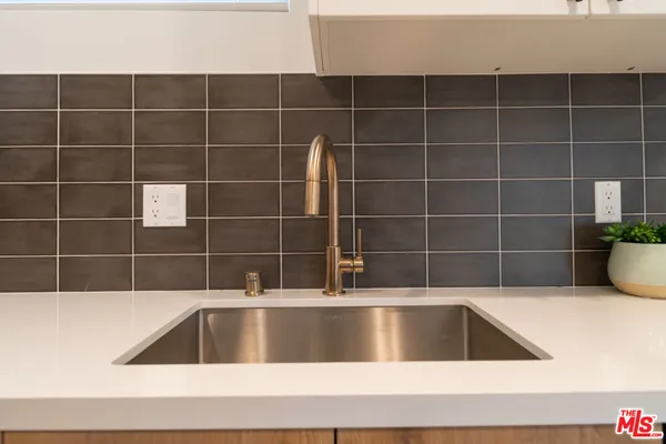 a view of a bathtub and potted in a bathroom