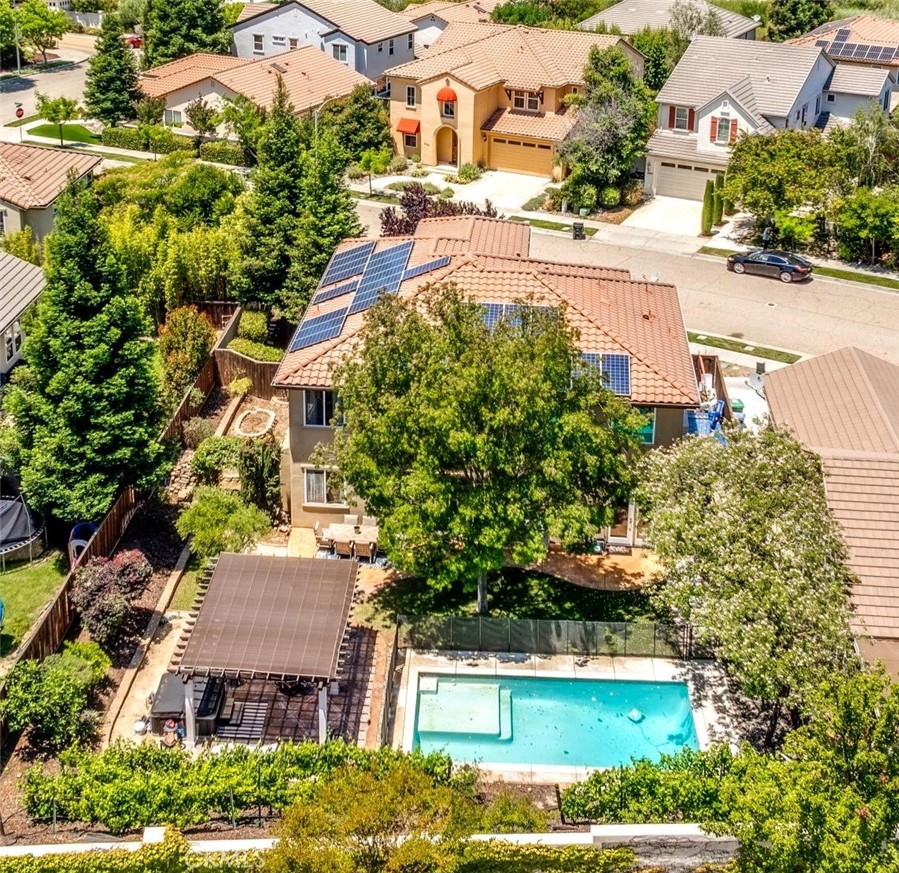 204 Vista Del Rio Court Paso Robles, CA 93446 - Photo 2 of 43 This property has the perfect backyard for summer: A refreshing pool, grassy area, multiple seating areas and a garden area on the side of the home.