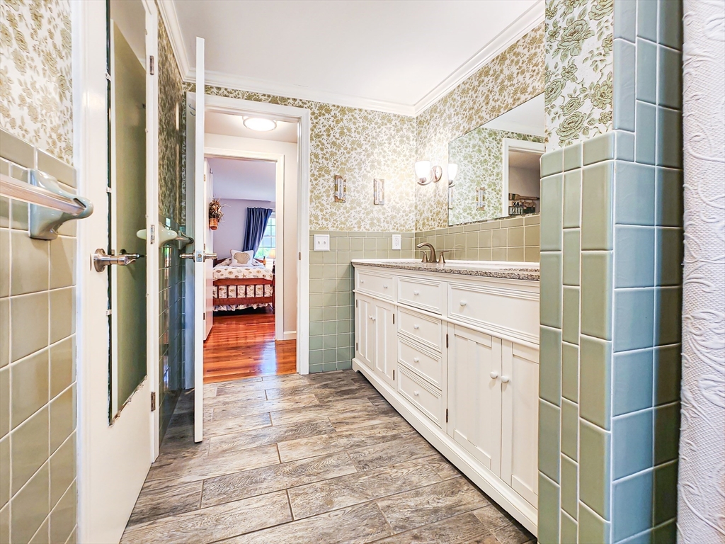 29 Sullivan Road Yarmouth, MA 02673 - Photo 13 of 42 a bathroom with a granite countertop sink a mirror and a shower