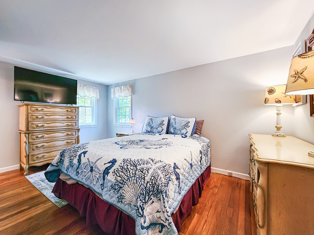 29 Sullivan Road Yarmouth, MA 02673 - Photo 15 of 42 a bedroom with a bed and a flat screen tv