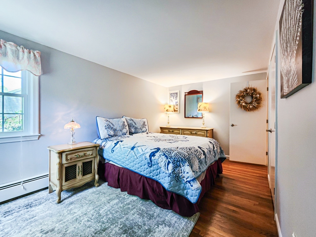 29 Sullivan Road Yarmouth, MA 02673 - Photo 16 of 42 a bedroom with a bed and a tv on table