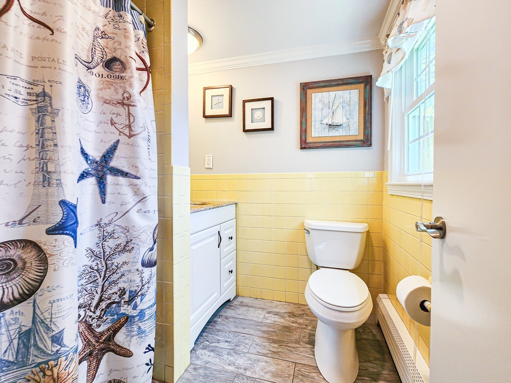 29 Sullivan Road Yarmouth, MA 02673 - Photo 18 of 42 a bathroom with a toilet and a shower curtain