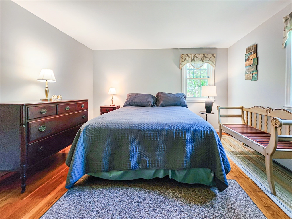 29 Sullivan Road Yarmouth, MA 02673 - Photo 20 of 42 a bedroom with a bed and a lamp with window