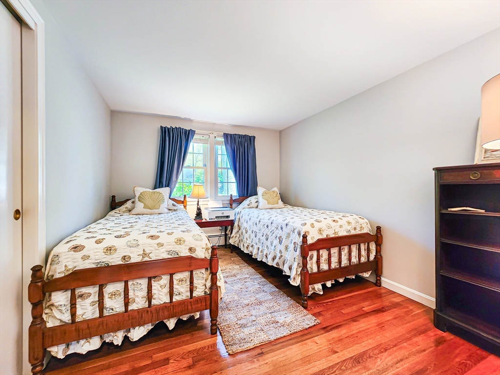29 Sullivan Road Yarmouth, MA 02673 - Photo 23 of 42 a bedroom with a bed and wooden floor