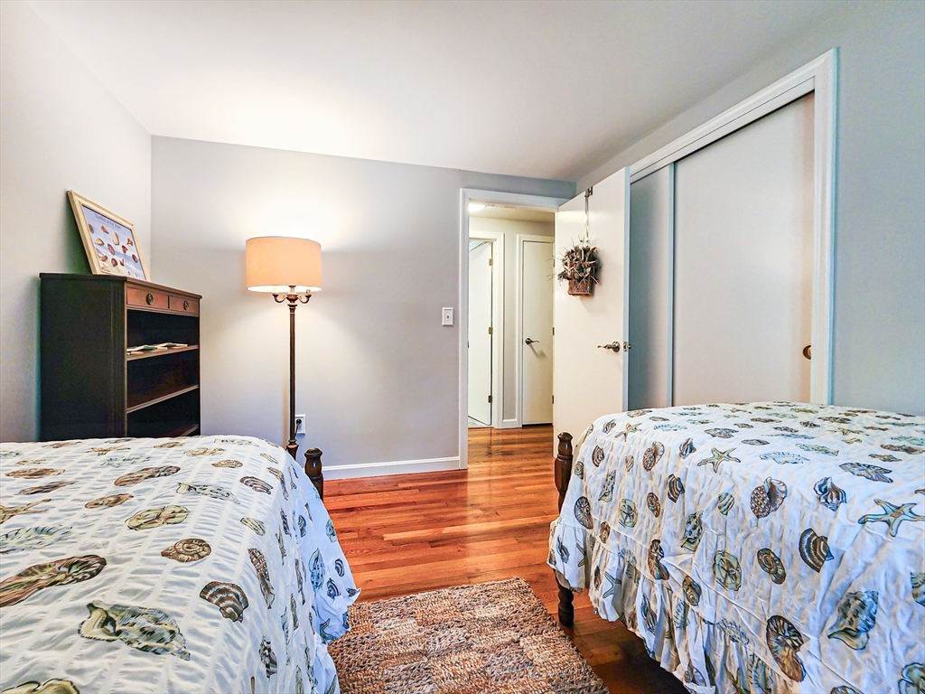 29 Sullivan Road Yarmouth, MA 02673 - Photo 24 of 42 a bedroom with a bed and a lamp on dresser