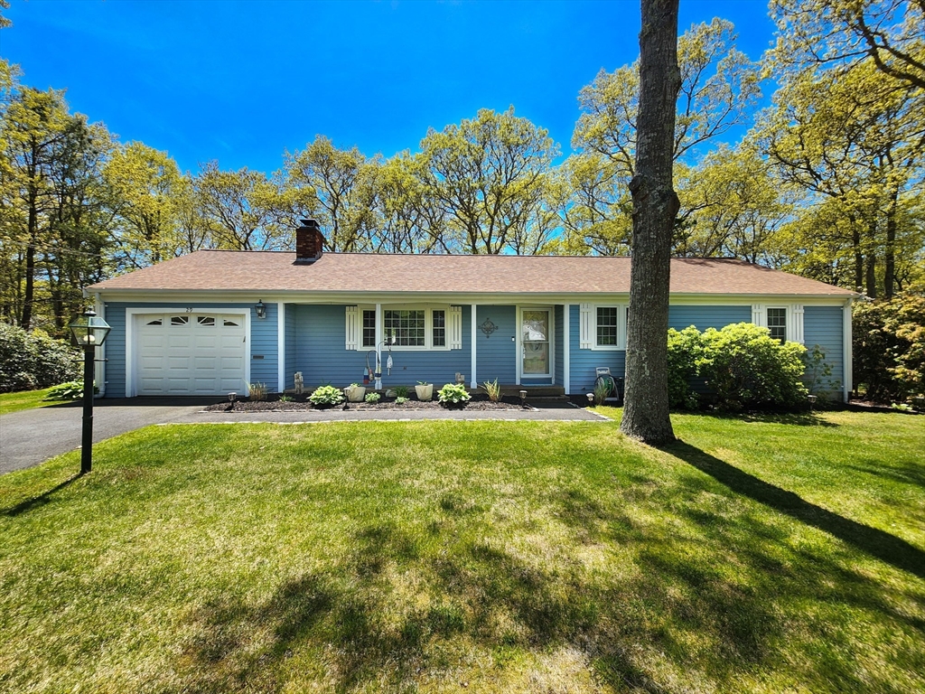 29 Sullivan Road Yarmouth, MA 02673 - Photo 26 of 42 a front view of a house with a yard