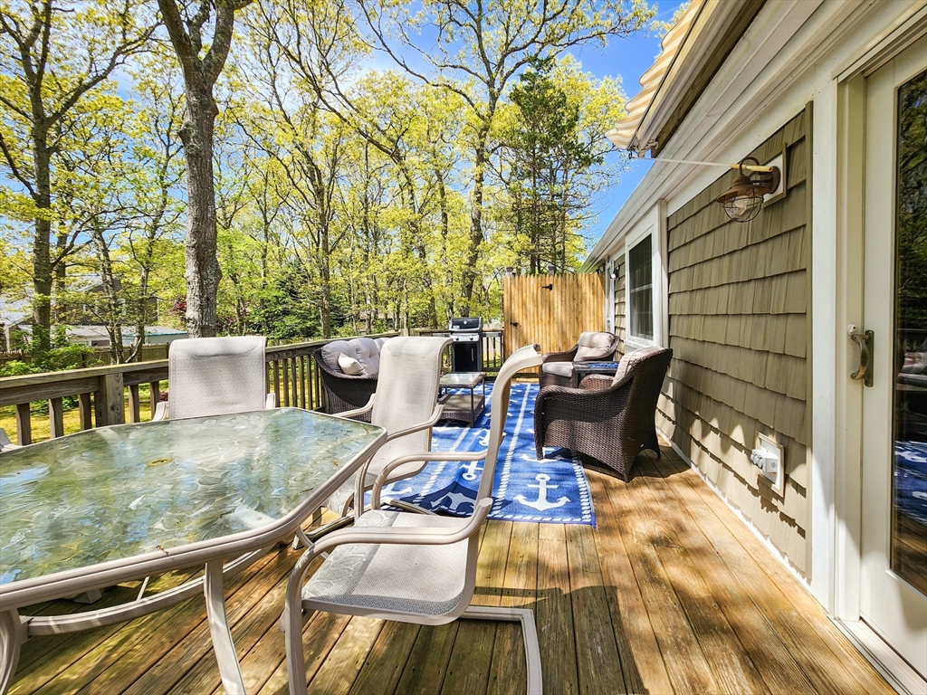 29 Sullivan Road Yarmouth, MA 02673 - Photo 33 of 42 a view of a patio with table and chairs and potted plants