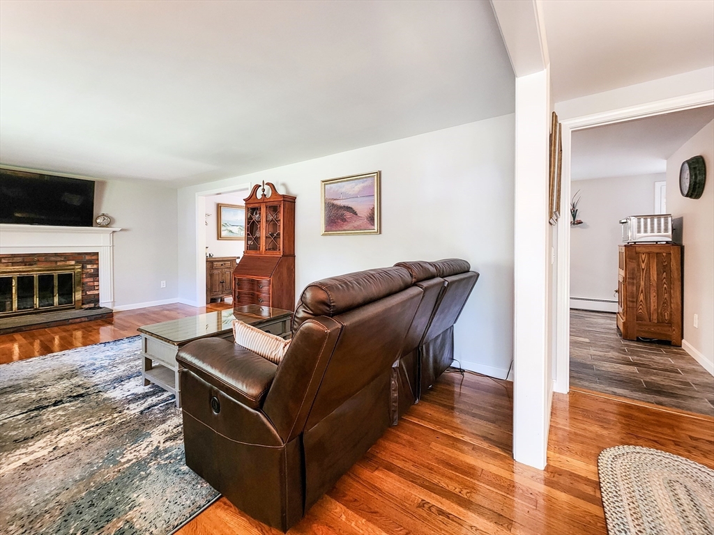 29 Sullivan Road Yarmouth, MA 02673 - Photo 4 of 42 a living room with furniture and a fireplace