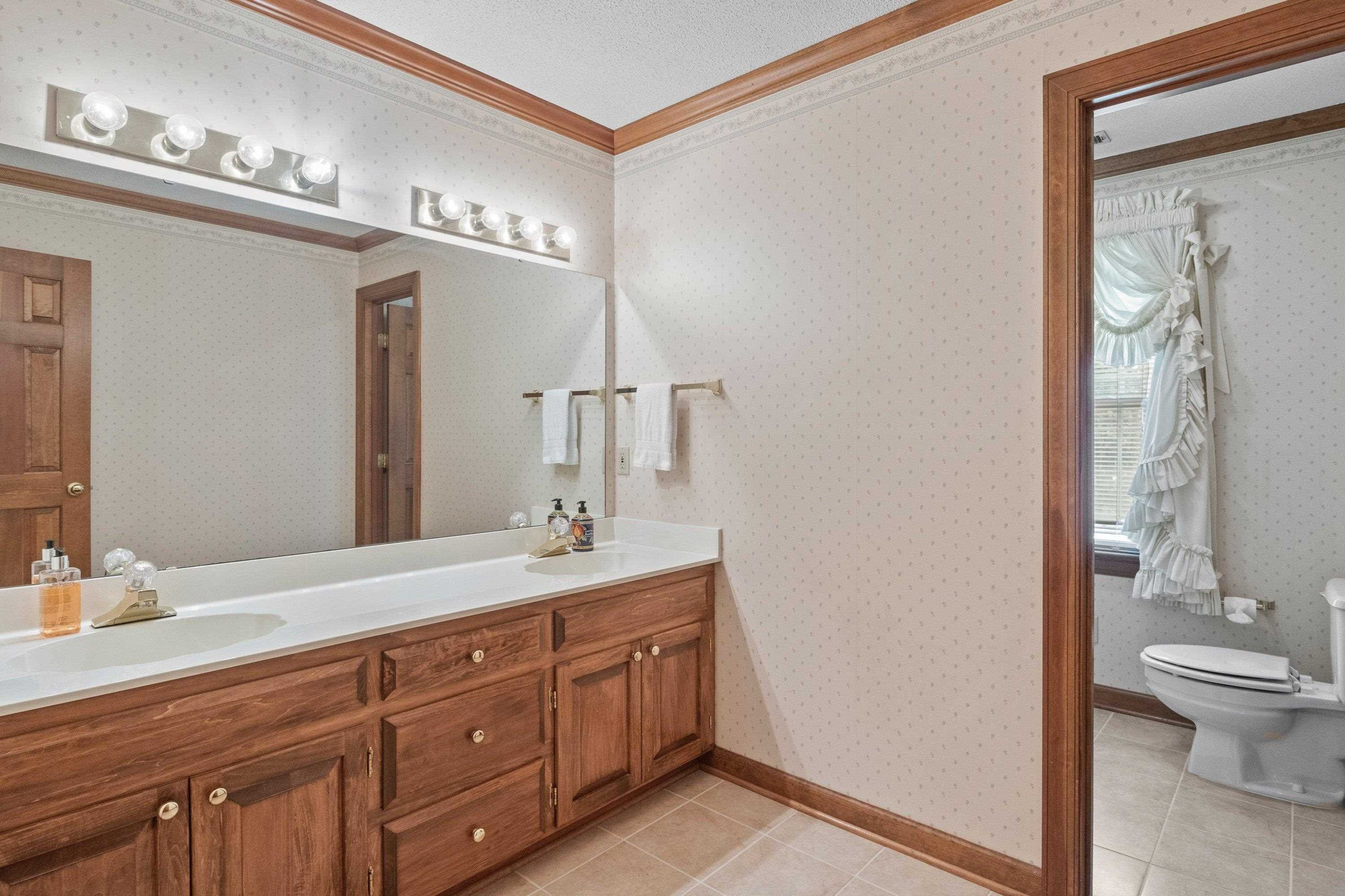 8501 Crowder Road Raleigh, NC 27603 - Photo 44 of 60 Vanity area and bath area are separated to accommodate multiple siblings. Hall Bath