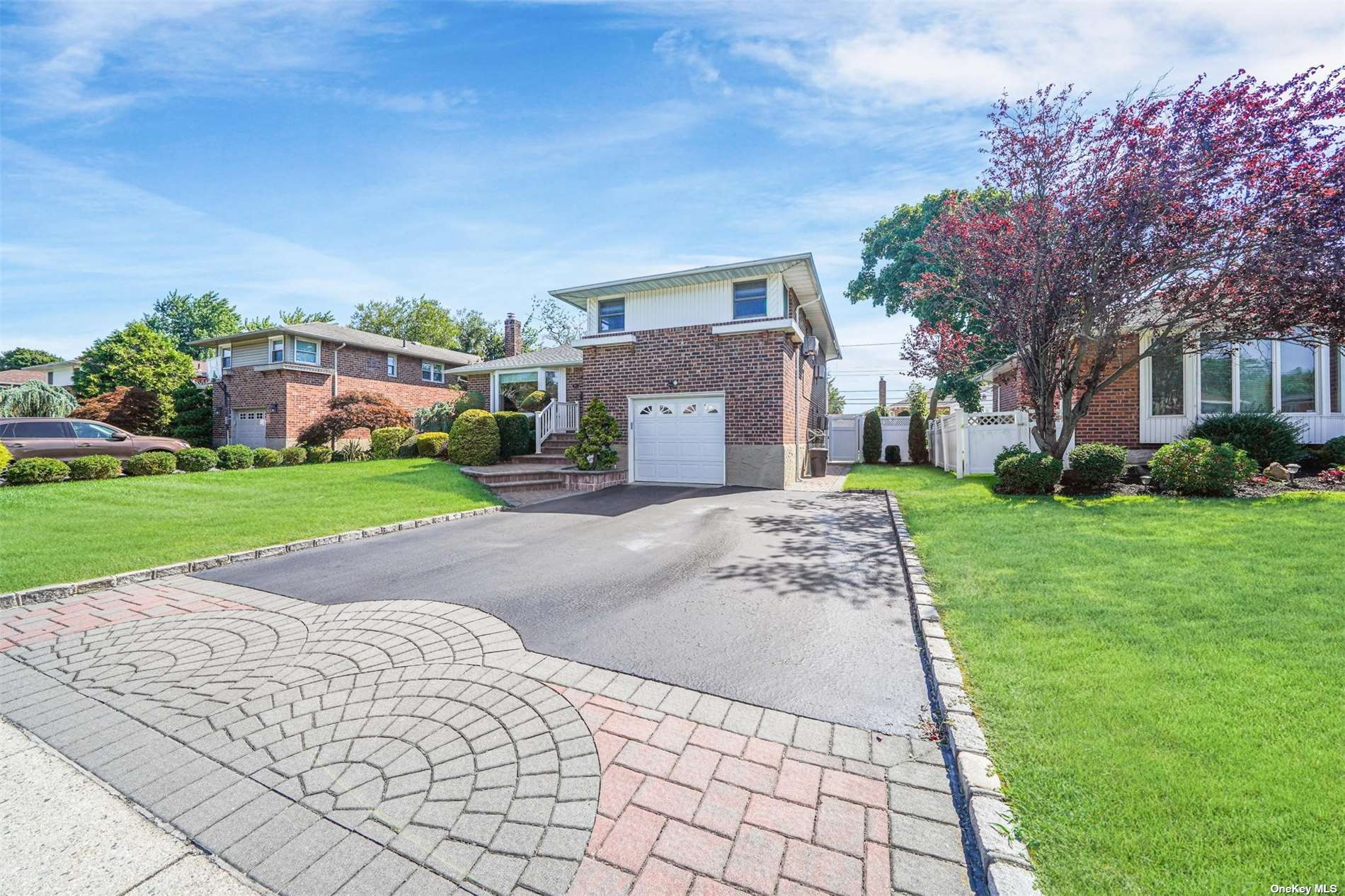 94 Gate Lane Levittown, NY 11756 - Photo 1 of 1 a front view of a house with a yard and garage