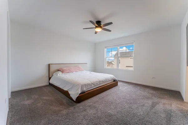 a bedroom with a bed and window