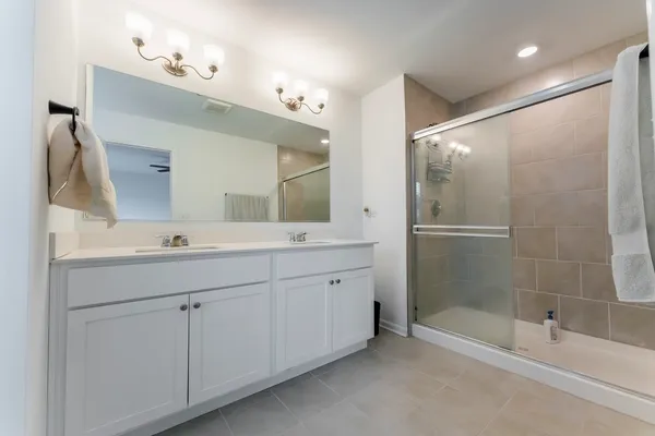 a bathroom with a shower sink and mirror