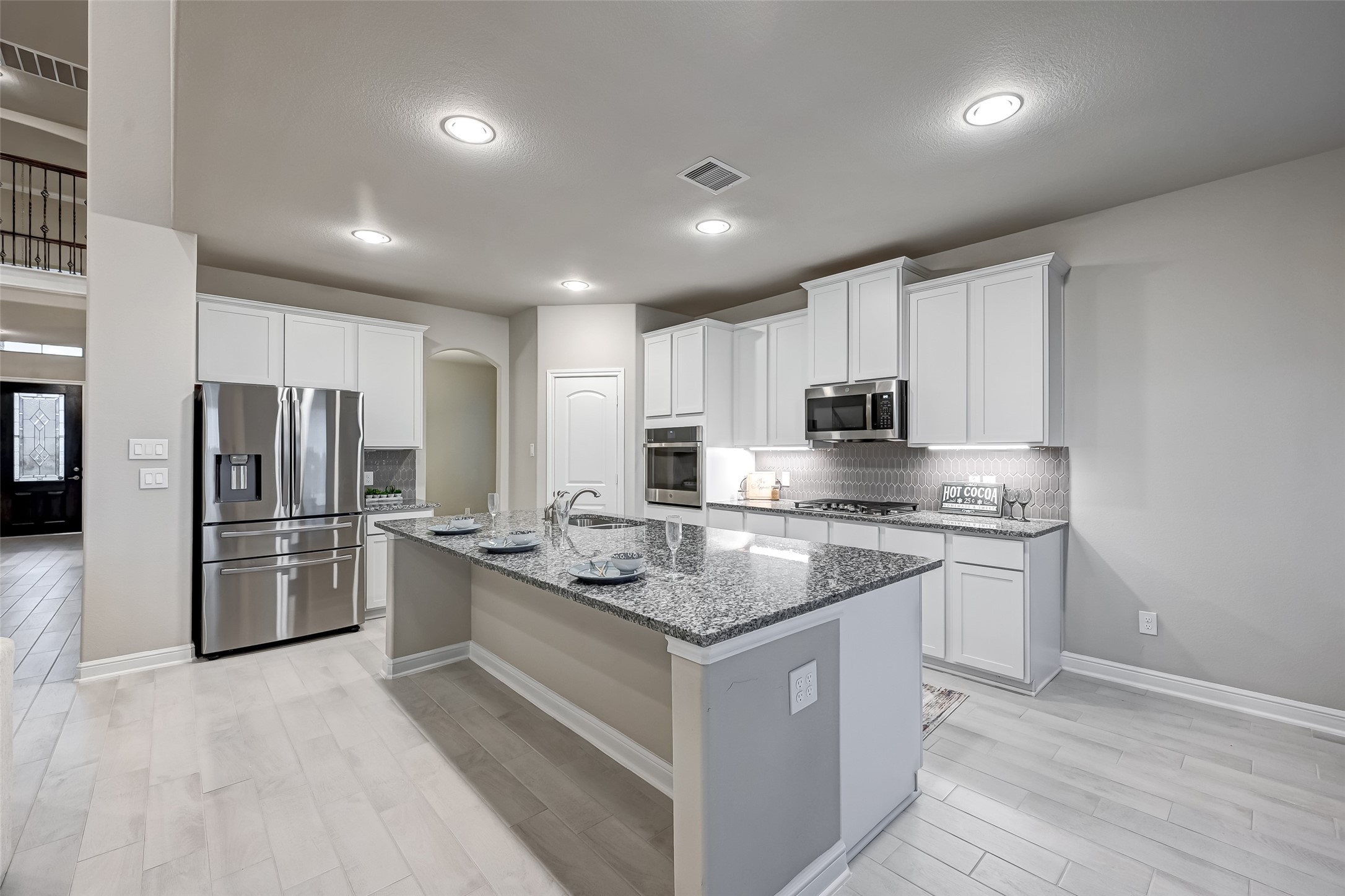 3327 Learning Tree Lane Rosenberg, TX 77471 - Photo 16 of 50 Gourmet island kitchen, adorned with sleek stainless-steel appliances, custom cabinetry, and expansive counter space perfect for entertaining in style.