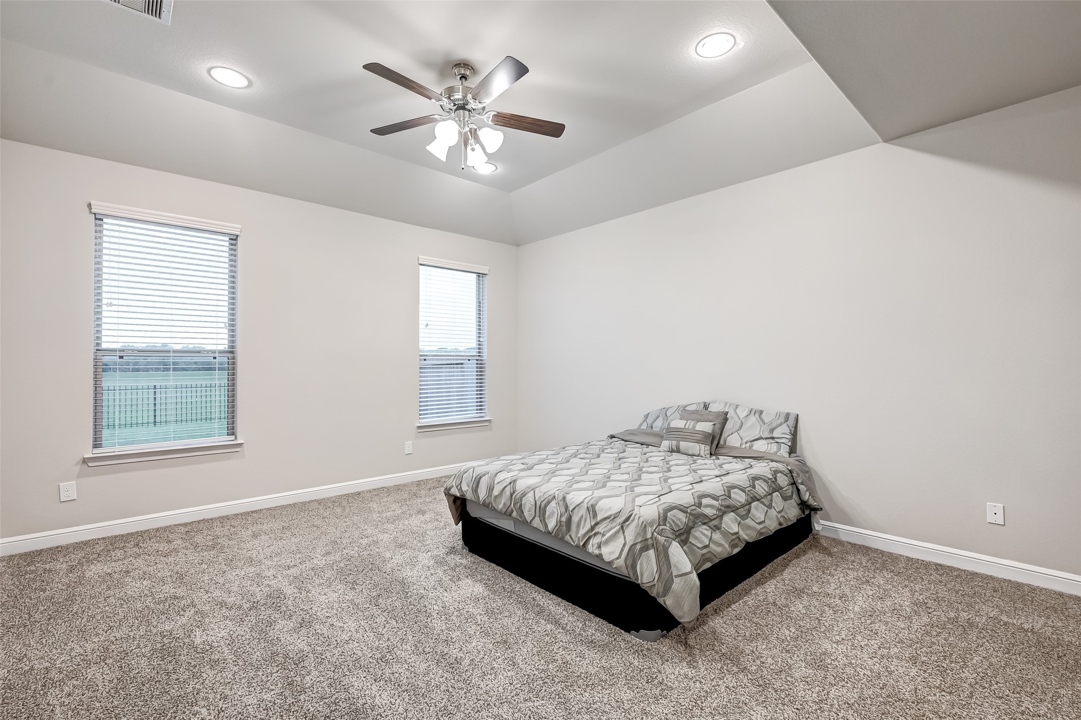 3327 Learning Tree Lane Rosenberg, TX 77471 - Photo 26 of 50 Large primary suite with tray ceilings, plush carpet and a serene view of the backyard