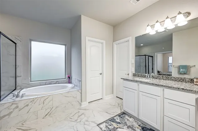 a spacious bathroom with a sink and a mirror
