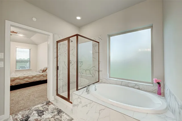a bathroom with a tub and a shower