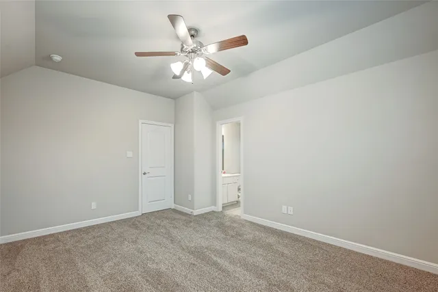 an empty room with a chandelier fan and a ceiling fan