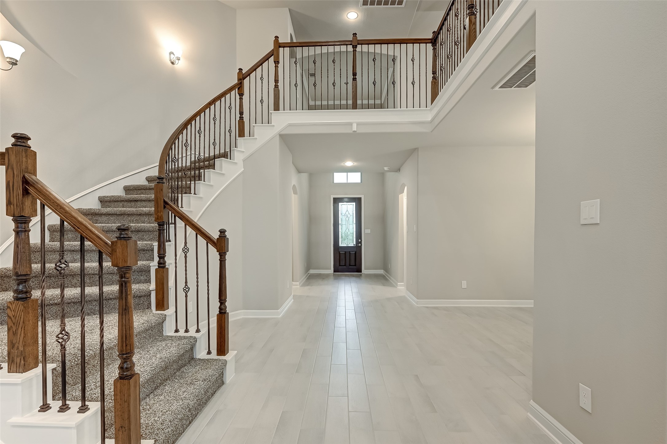 3327 Learning Tree Lane Rosenberg, TX 77471 - Photo 8 of 50 Grand entrance with 8 ft wooden door and circular staircase w/wrought-iron railing
