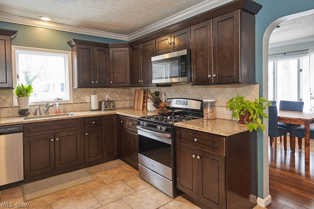 The kitchen has granite counters and tile backsplash.