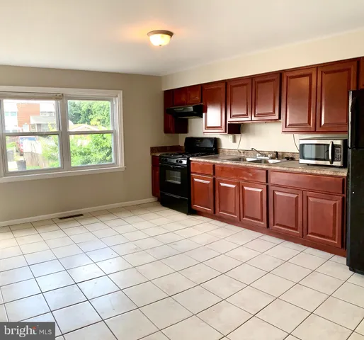 a kitchen with stainless steel appliances granite countertop a stove sink and cabinets