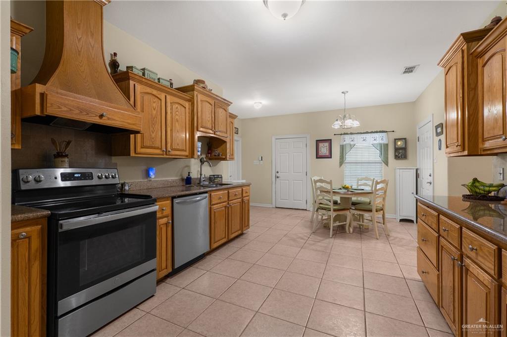 605 South Whalen Road Donna, TX 78537 - Photo 7 of 21 Dining area featuring a vaulted ceiling and tile flooring