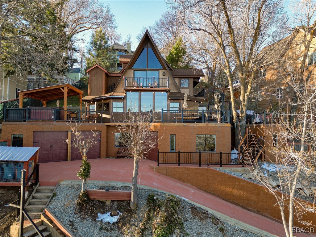28971 Banff Drive Lake Arrowhead, CA 92352 - Photo 1 of 46 a view of a house with backyard and sitting area