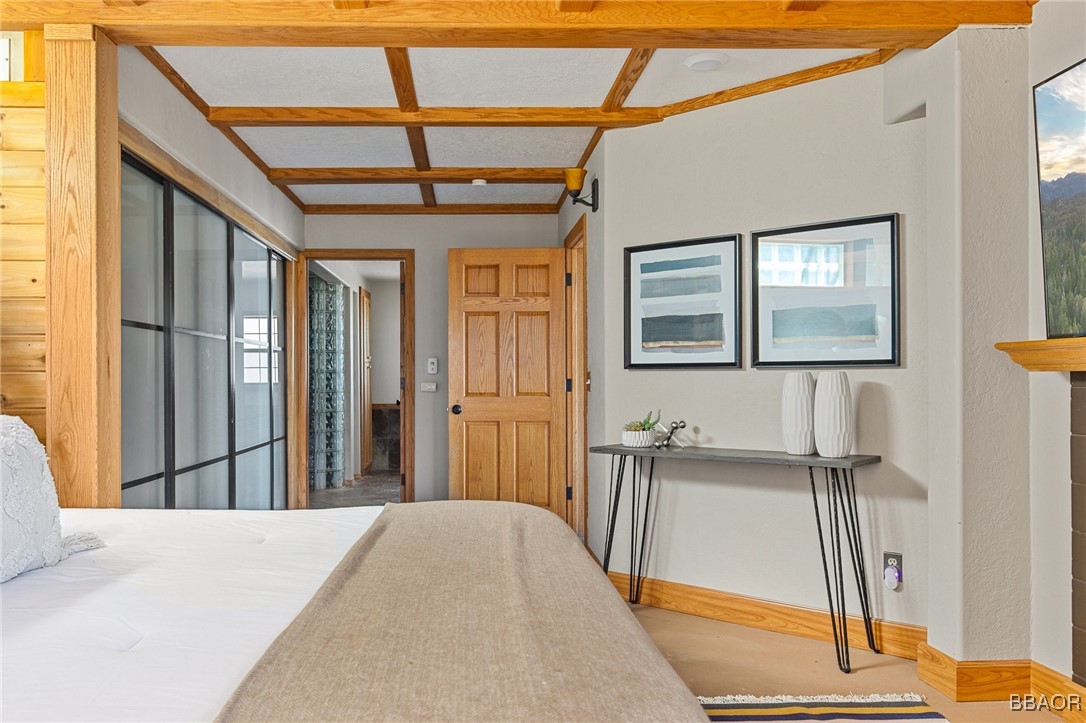 28971 Banff Drive Lake Arrowhead, CA 92352 - Photo 15 of 46 a bedroom with a bed and wooden floor