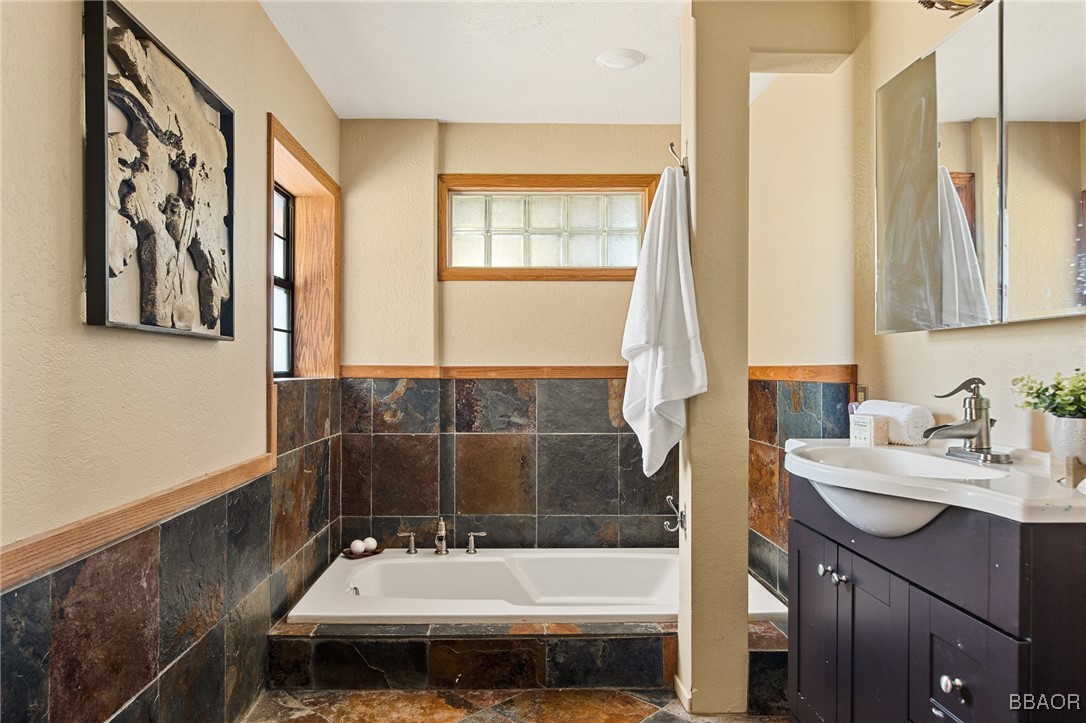 28971 Banff Drive Lake Arrowhead, CA 92352 - Photo 19 of 46 a bathroom with a sink and a bathtub
