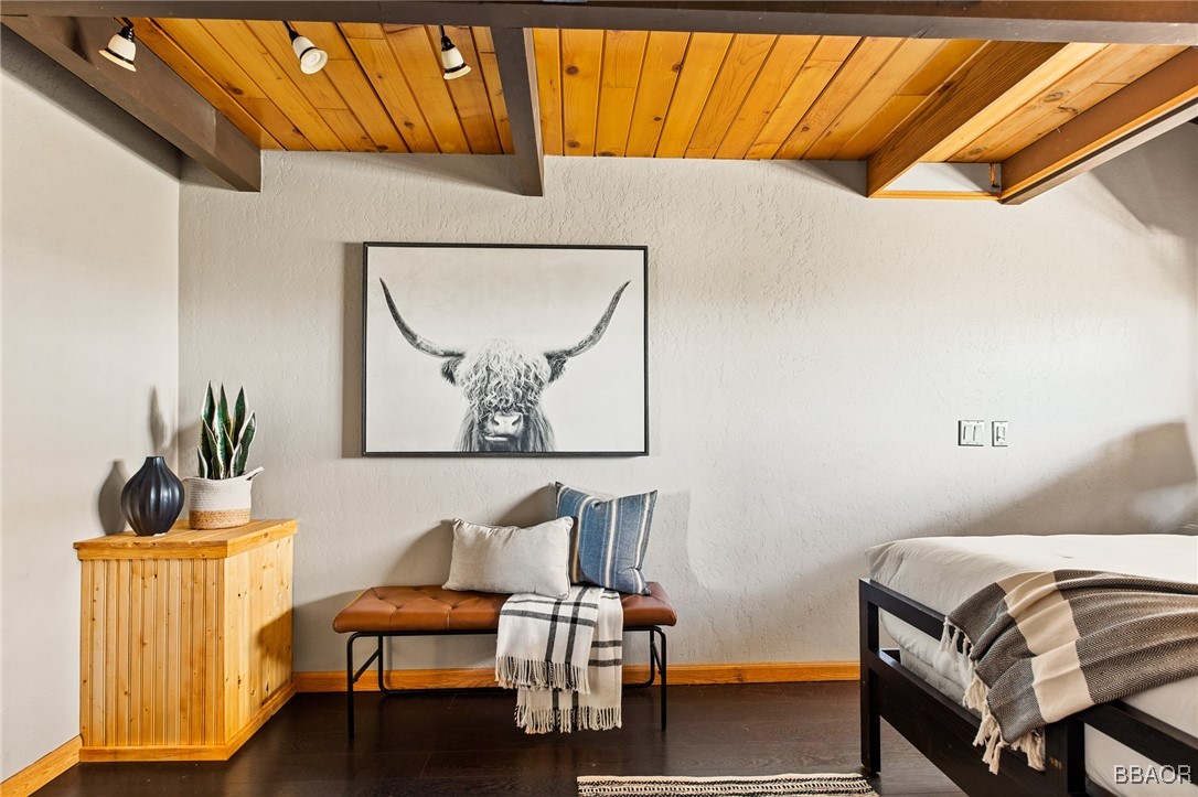 28971 Banff Drive Lake Arrowhead, CA 92352 - Photo 21 of 46 a bedroom with a bed and wooden floor