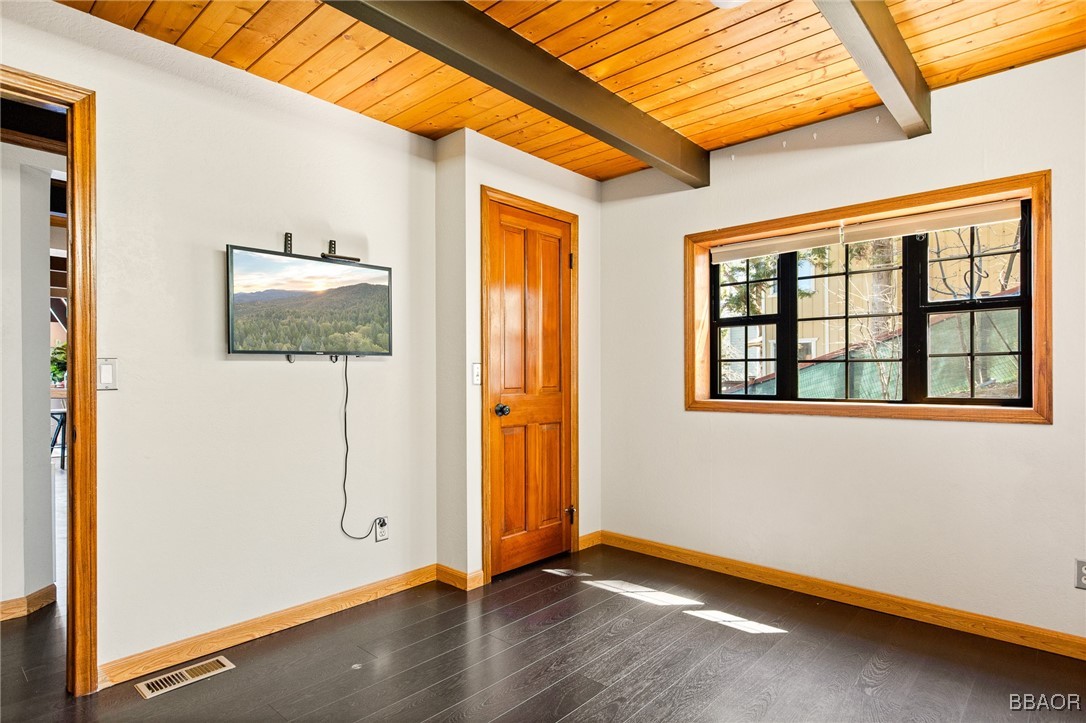 28971 Banff Drive Lake Arrowhead, CA 92352 - Photo 24 of 46 an empty room with wooden floor and windows