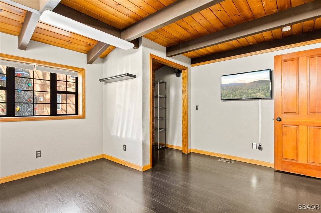 28971 Banff Drive Lake Arrowhead, CA 92352 - Photo 25 of 46 a view of an empty room with wooden floor and a window