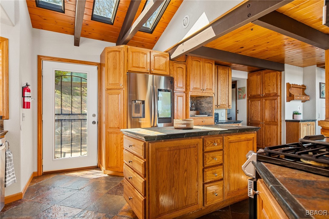 28971 Banff Drive Lake Arrowhead, CA 92352 - Photo 9 of 46 a kitchen with stainless steel appliances granite countertop a stove a sink and a refrigerator