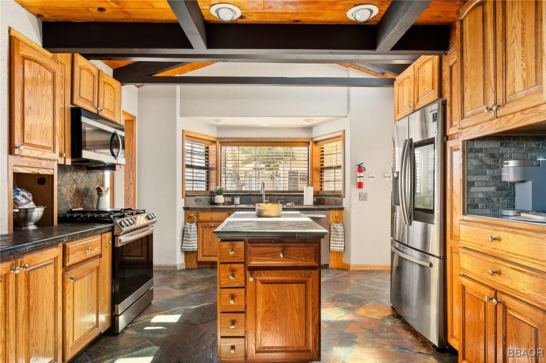 28971 Banff Drive Lake Arrowhead, CA 92352 - Photo 10 of 46 a kitchen with stainless steel appliances granite countertop a stove and a refrigerator