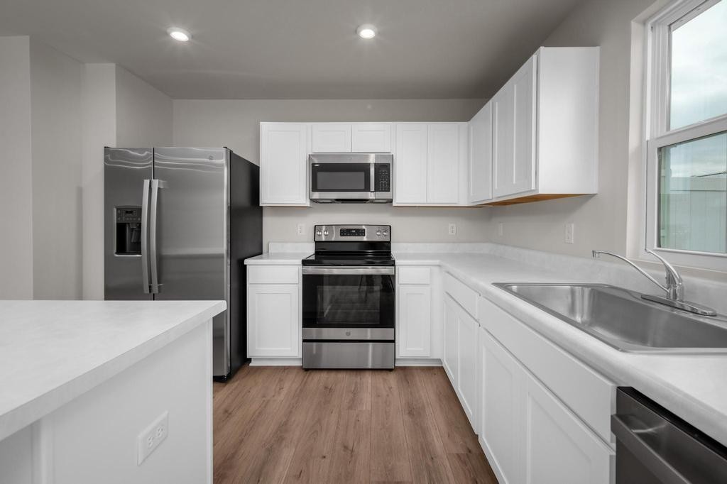 1110 Aubrey Meadows Place Franklin, KY 42134 - Photo 8 of 20 a kitchen with a refrigerator stove and sink
