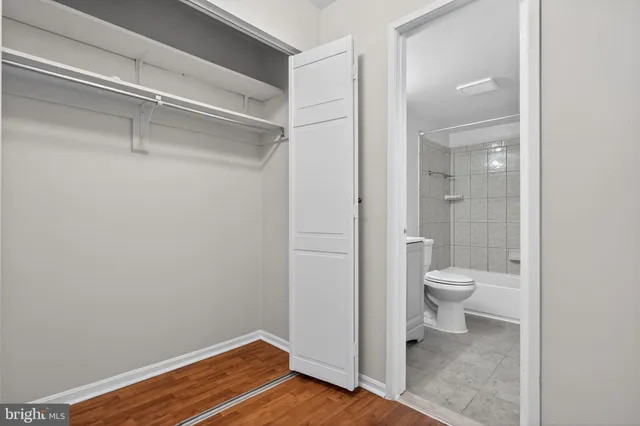 a bathroom view of a toilet and a shower