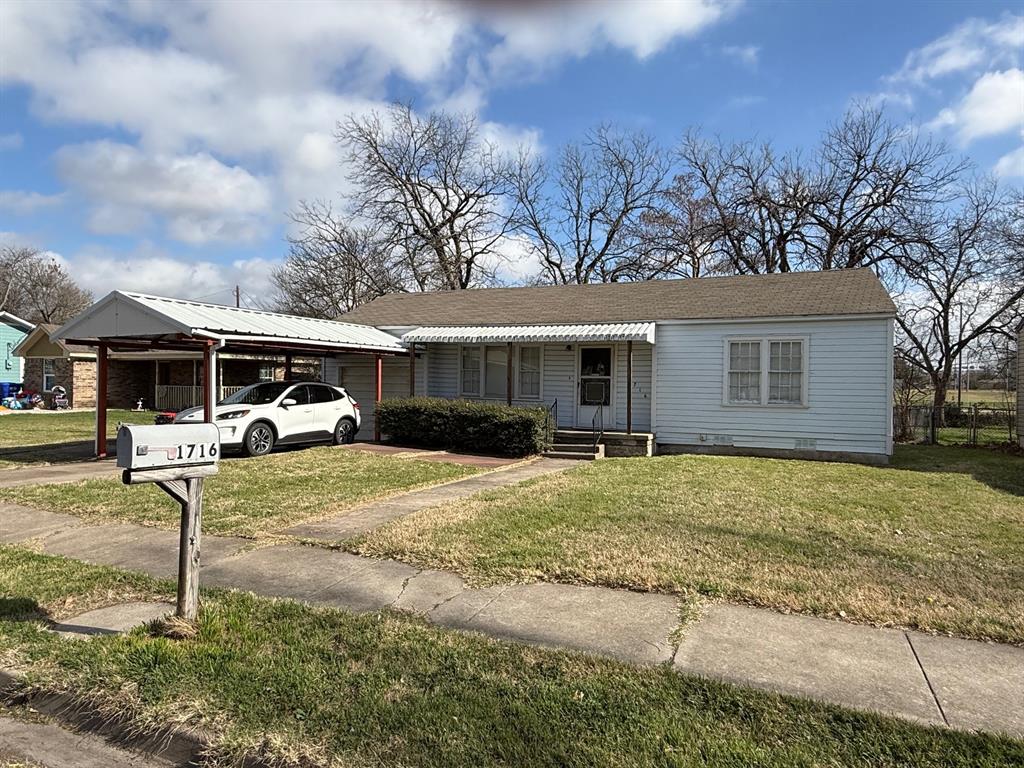 1716 Sheppard Street Waco, TX 76711 - Photo 1 of 13 a front view of a house with a yard and garage