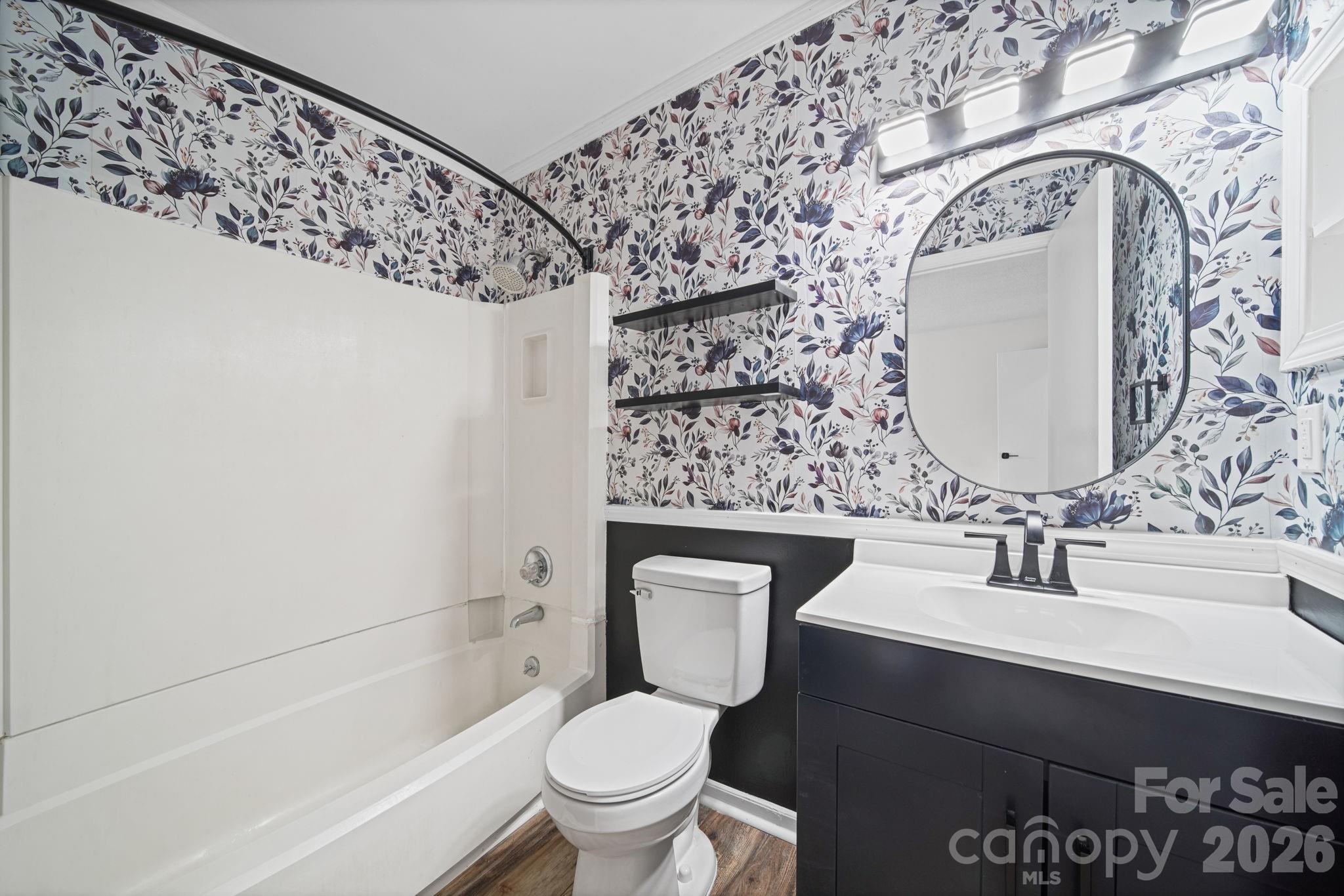 11023 Harrowfield Road Charlotte, NC 28226 - Photo 22 of 32 a bathroom with a toilet sink and mirror