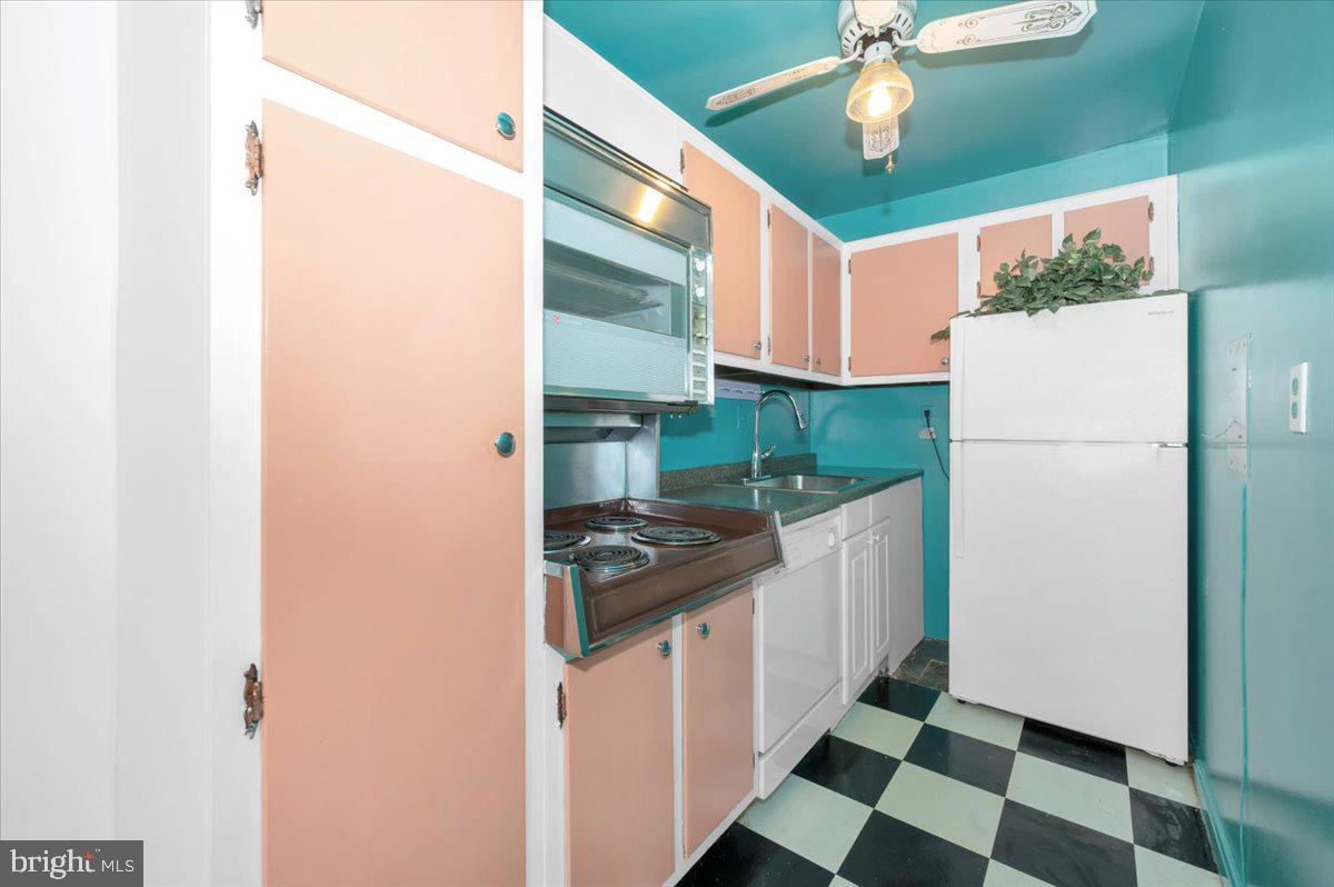 9701 Fields Road, Unit 2206 Gaithersburg, MD 20878 - Photo 13 of 30 a kitchen with a refrigerator a sink and dishwasher