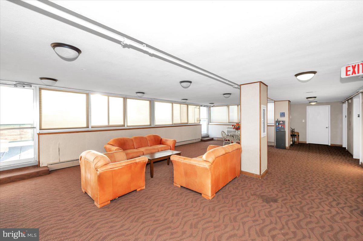 9701 Fields Road, Unit 2206 Gaithersburg, MD 20878 - Photo 20 of 30 a living room with furniture and a large window
