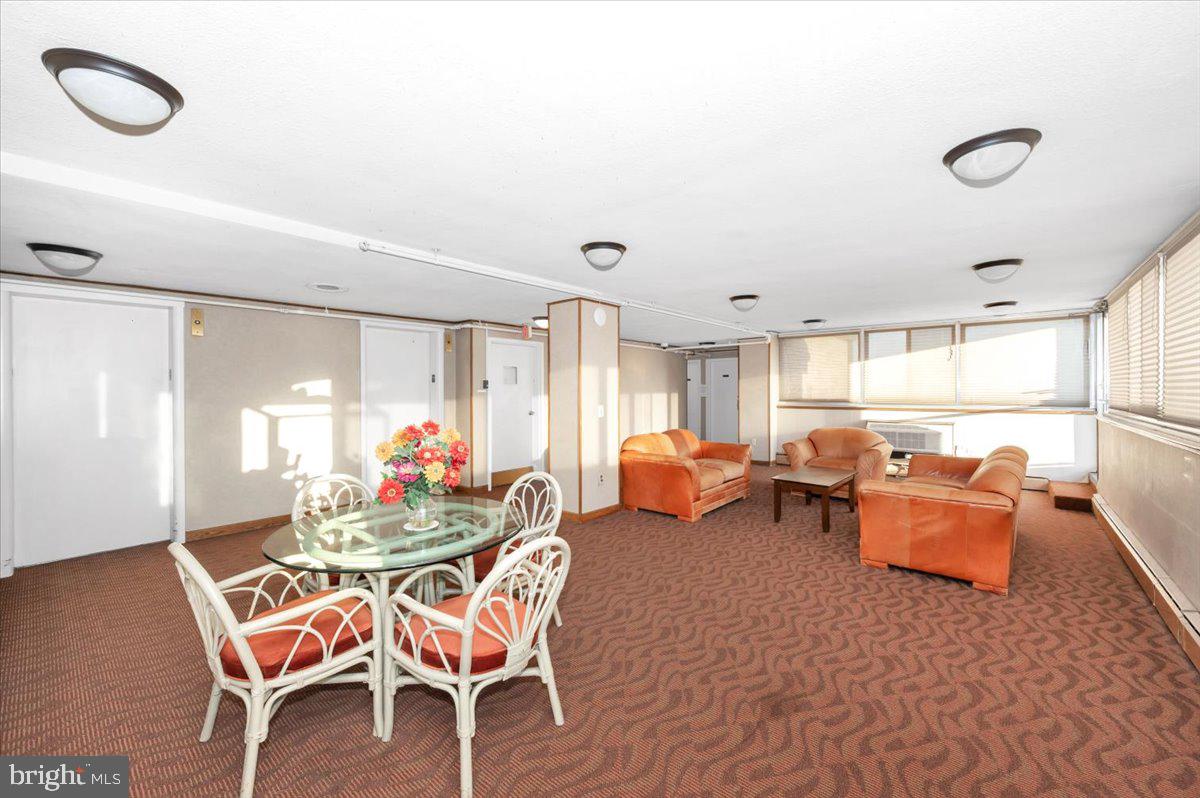 9701 Fields Road, Unit 2206 Gaithersburg, MD 20878 - Photo 21 of 30 a view of a dining room with furniture and chandelier